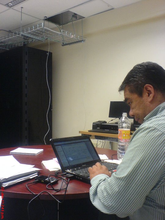 Professional working at a desk with a laptop, side profile, soft studio lighting